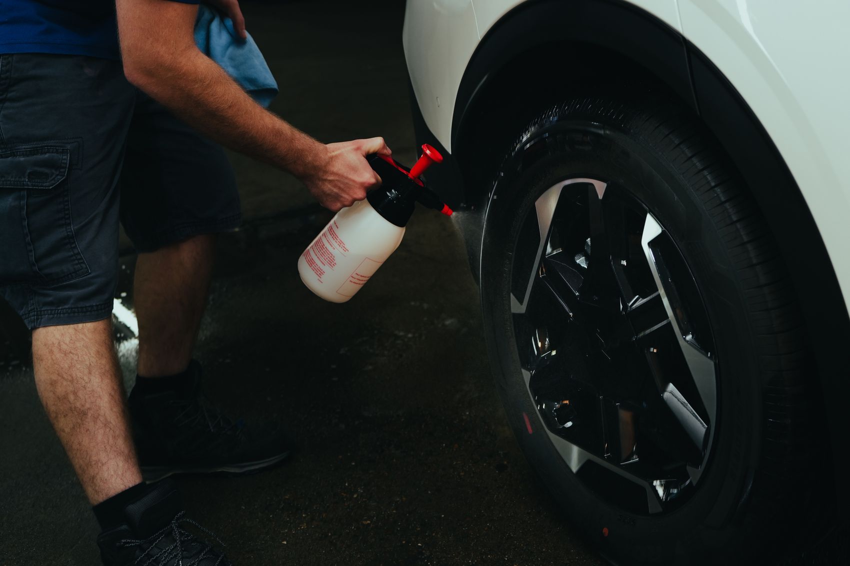 EV wheel and tyre being cleaned and checked at low level