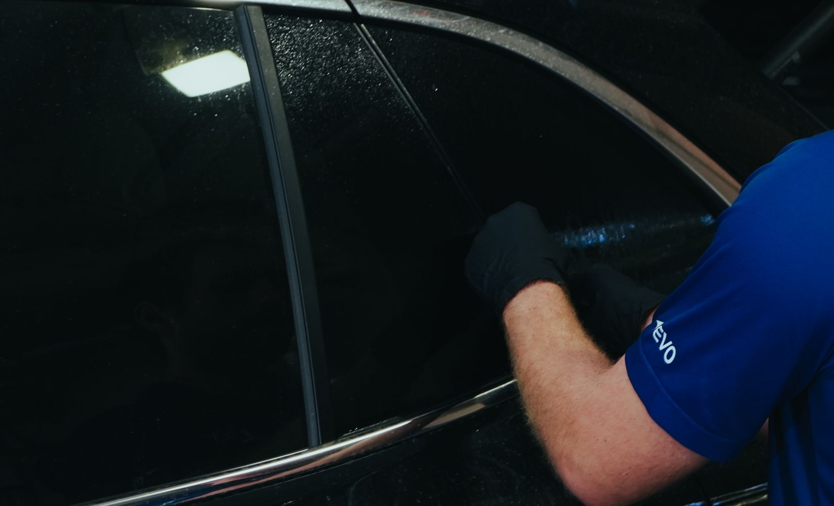 Metal-free ceramic tint film being fitted to an EV side window in Brisbane