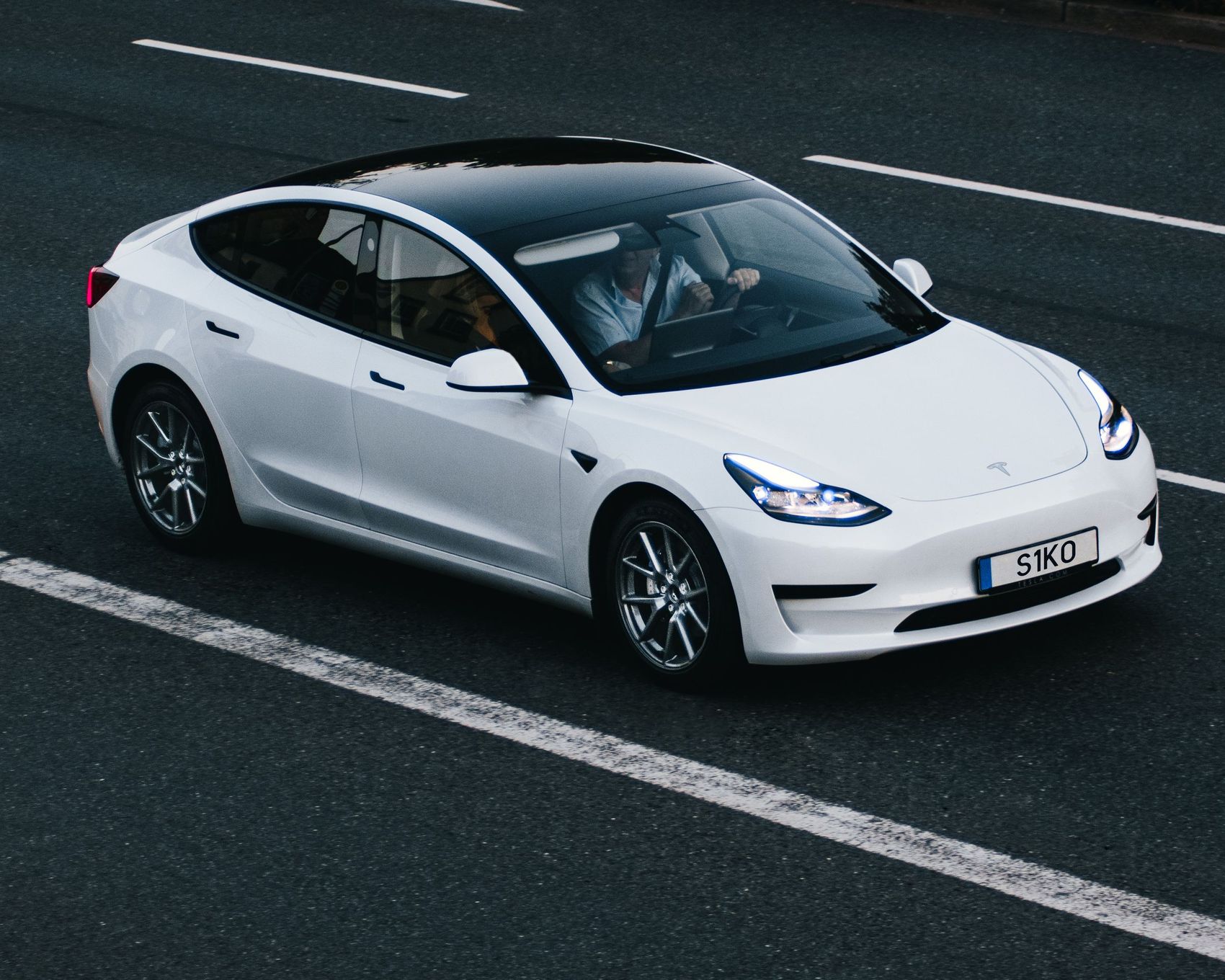 White Tesla Model 3 on the road